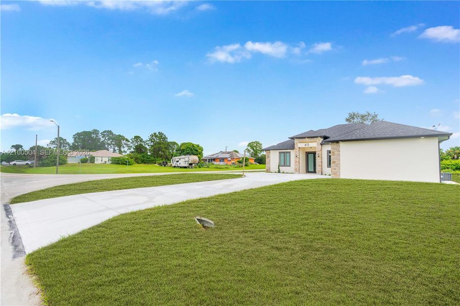 Front exterior of a new home in , Lehigh Acres, FL, highlighting curb appeal (Image 26). Front exterior of a new home in , Lehigh Acres, FL, highlighting curb appeal (Image 26).