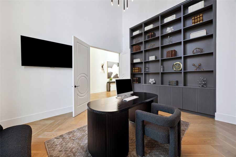 Home office from a different perspective showcasing the custom built in book shelves and cabinetry