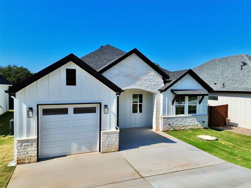 Front exterior of a new home in , Granbury, TX, highlighting curb appeal (Image 2). Front exterior of a new home in , Granbury, TX, highlighting curb appeal (Image 2).