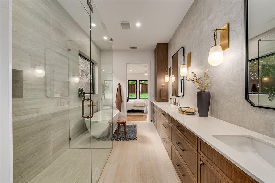 Full bath featuring ensuite bath, a freestanding tub, double vanity, a stall shower, and recessed lighting Full bath featuring ensuite bath, a freestanding tub, double vanity, a stall shower, and recessed lighting