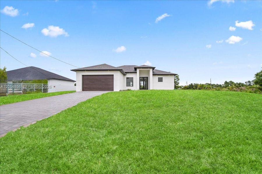 Front exterior of a new home in , Lehigh Acres, FL, highlighting curb appeal (Image 1). Front exterior of a new home in , Lehigh Acres, FL, highlighting curb appeal (Image 1).
