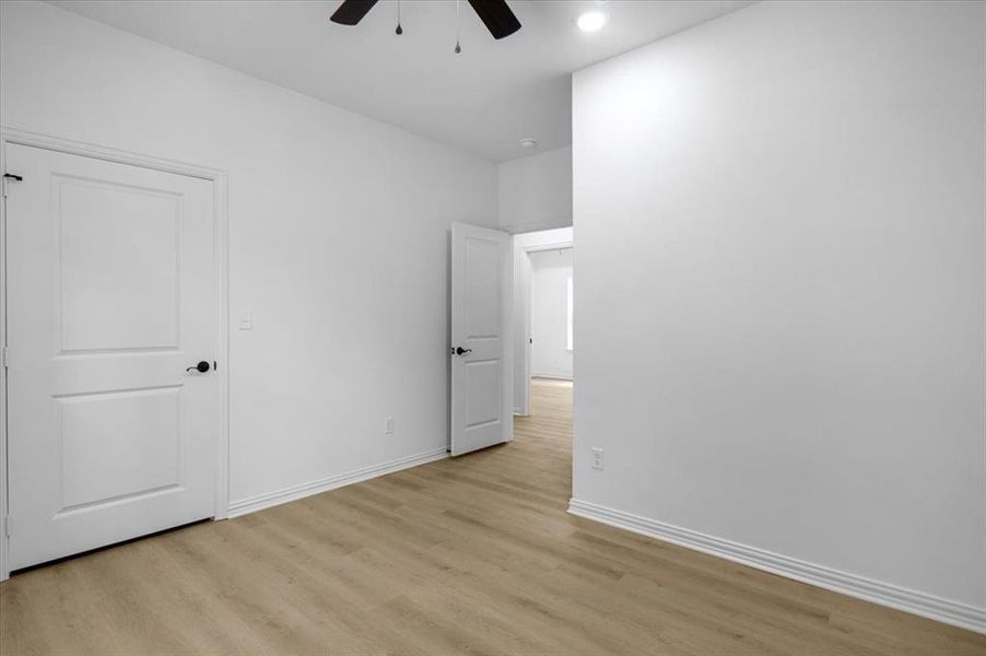 Unfurnished bedroom featuring light wood-style flooring and a ceiling fan
