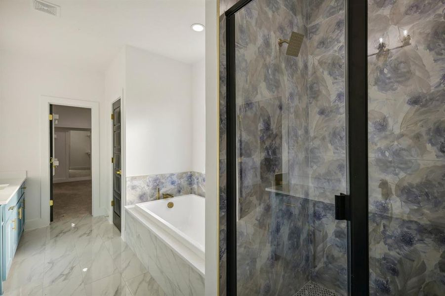 Bathroom featuring vanity and shower with separate bathtub