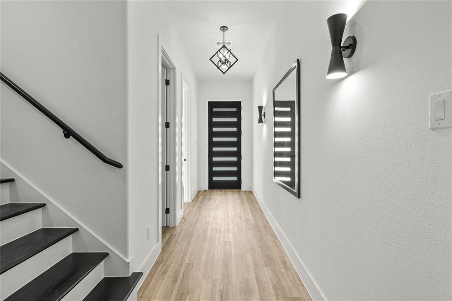 Hall featuring light wood-type flooring and stairs