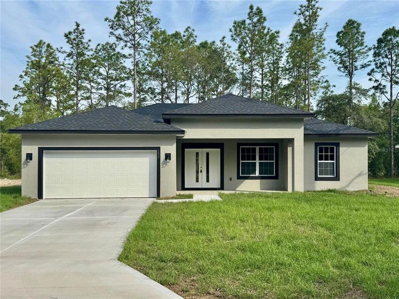 Front exterior of a new home in , Citrus Springs, FL, highlighting curb appeal (Image 1).