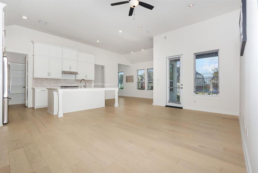 Unfurnished living room featuring light wood finished floors, recessed lighting, and ceiling fan Unfurnished living room featuring light wood finished floors, recessed lighting, and ceiling fan