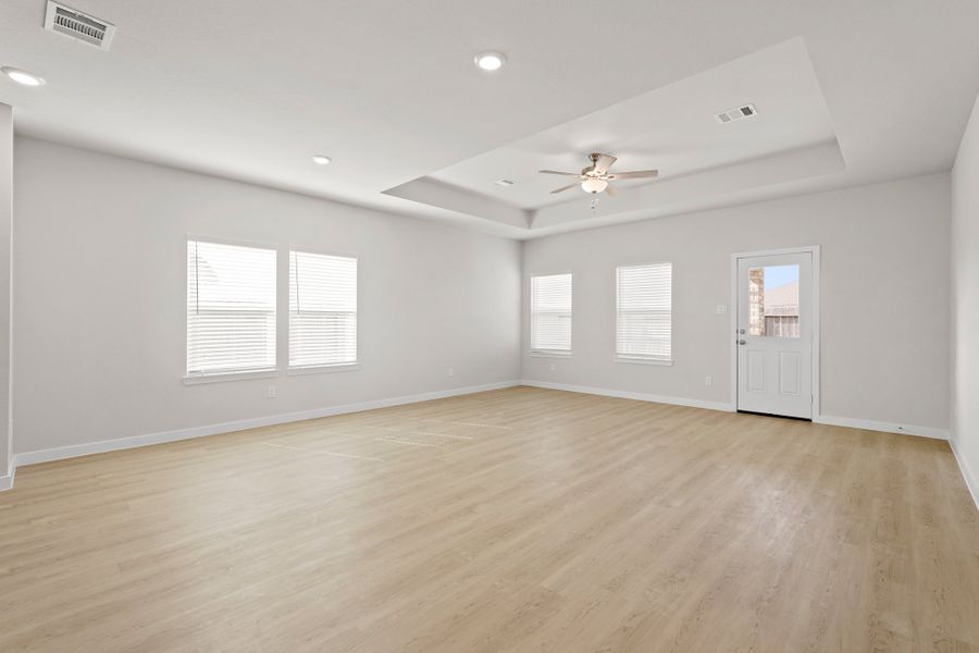 A room with a wood floor and a ceiling fan. A room with a wood floor and a ceiling fan.