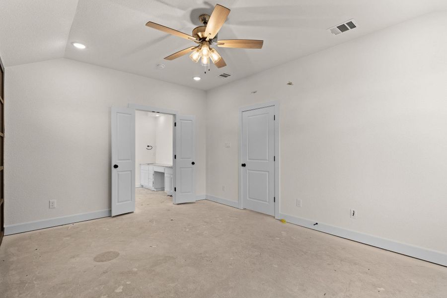 Unfurnished bedroom with unfinished concrete flooring and recessed lighting Unfurnished bedroom with unfinished concrete flooring and recessed lighting