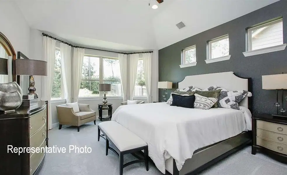 Bedroom featuring vaulted ceiling and carpet