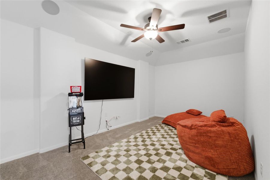 A dedicated media room offers comfortable seating and carpeted flooring for entertainment. A dedicated media room offers comfortable seating and carpeted flooring for entertainment.