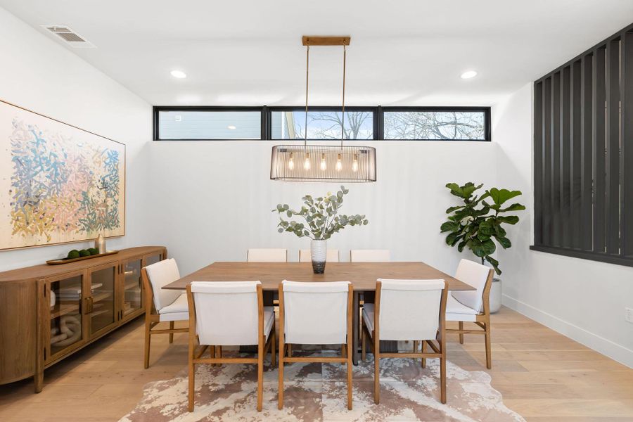 Dining space with recessed lighting, light wood-style floors, visible vents, and baseboards