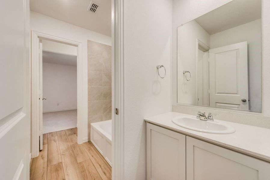 Bathroom featuring vanity and wood-type flooring