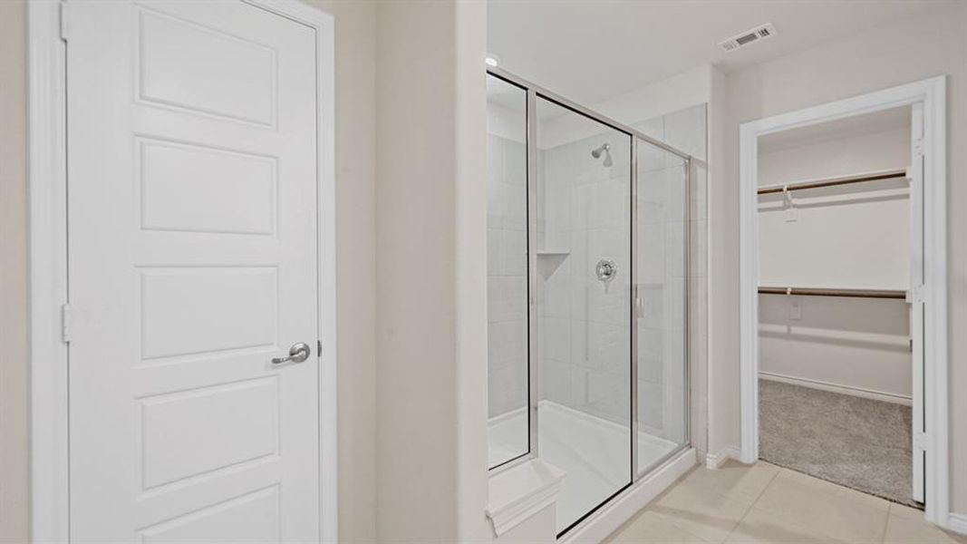 Walk-in shower with clear glass enclosure and subway tile surround, featuring an integrated shower niche Walk-in shower with clear glass enclosure and subway tile surround, featuring an integrated shower niche