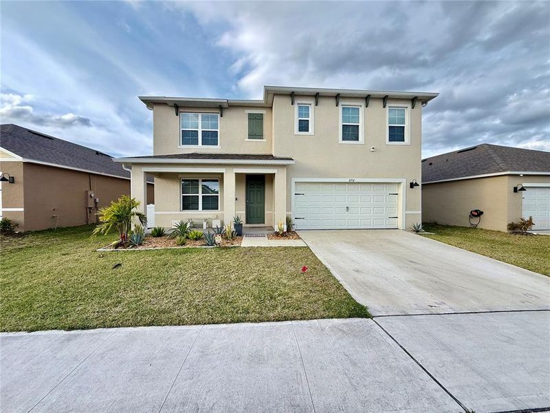 Front exterior of a new home in Harmony West, St. Cloud, FL, highlighting curb appeal (Image 25).