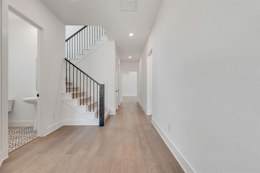 Entryway featuring light wood-type flooring, stairs, and recessed lighting Entryway featuring light wood-type flooring, stairs, and recessed lighting