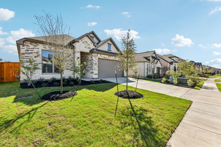 Front exterior of a new home in 6 Creeks, Kyle, TX, highlighting curb appeal (Image 18).