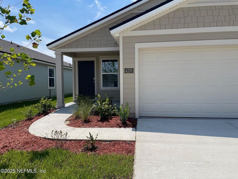 Front exterior of a new home in The Arbors, Jacksonville, FL, highlighting curb appeal (Image 19). Front exterior of a new home in The Arbors, Jacksonville, FL, highlighting curb appeal (Image 19).