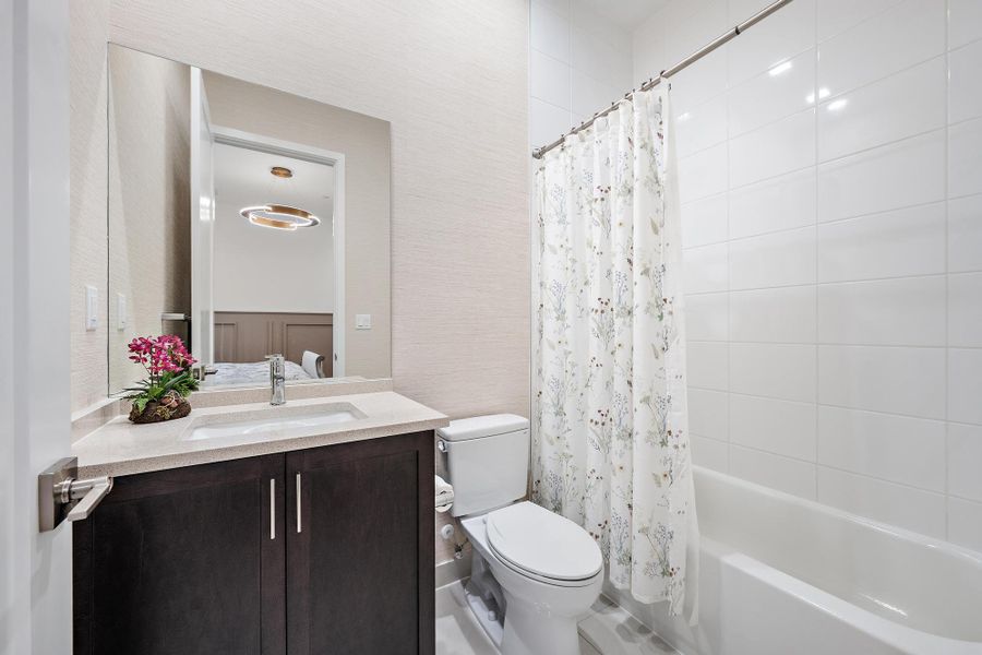 Upgraded tile, vanity, and designer wallpaper.