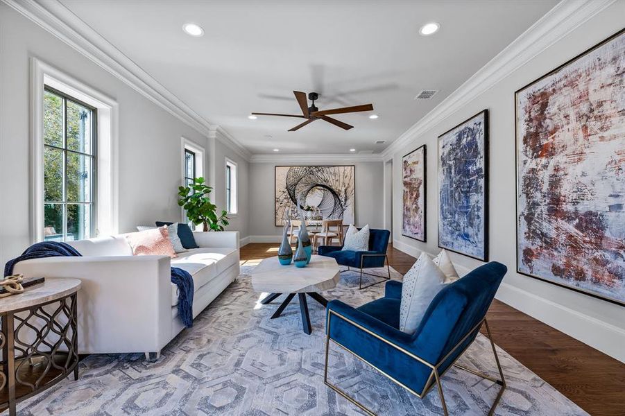 Living room featuring ceiling fan, light hardwood / wood-style floors, and ornamental molding