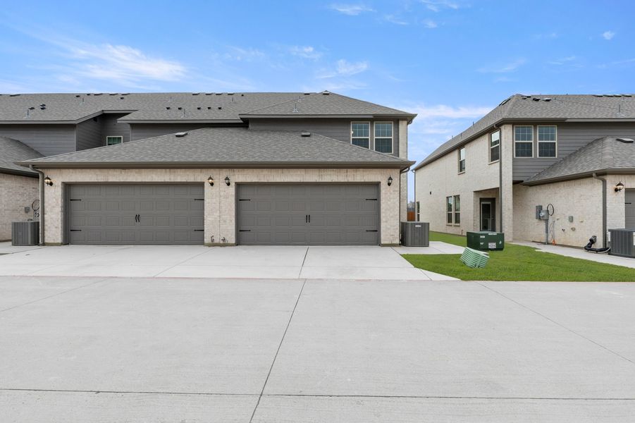 Front exterior of a new home in Sanger Circle – Townhomes, Sanger, TX, highlighting curb appeal (Image 27). Front exterior of a new home in Sanger Circle – Townhomes, Sanger, TX, highlighting curb appeal (Image 27).