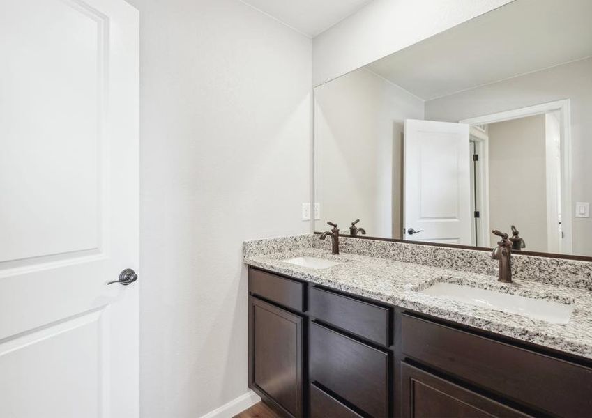 Secondary bathroom with a dual sink vanity.