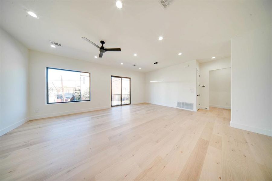 Unfurnished room with ceiling fan and light wood-type flooring