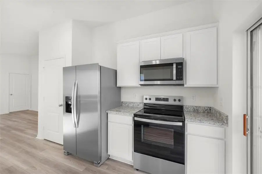 Furnished interior view inside a new home in Tula Parc, Astatula (Image 5).