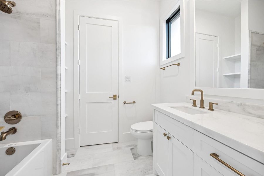 Natural light, classic stone finishes, and a tub and shower combination create a clean, functional layout suited for daily use. Ample vanity storage and built in shelving support organization while maintaining a bright, timeless feel.**Previous build by Arch Angelo** Natural light, classic stone finishes, and a tub and shower combination create a clean, functional layout suited for daily use. Ample vanity storage and built in shelving support organization while maintaining a bright, timeless feel.**Previous build by Arch Angelo**
