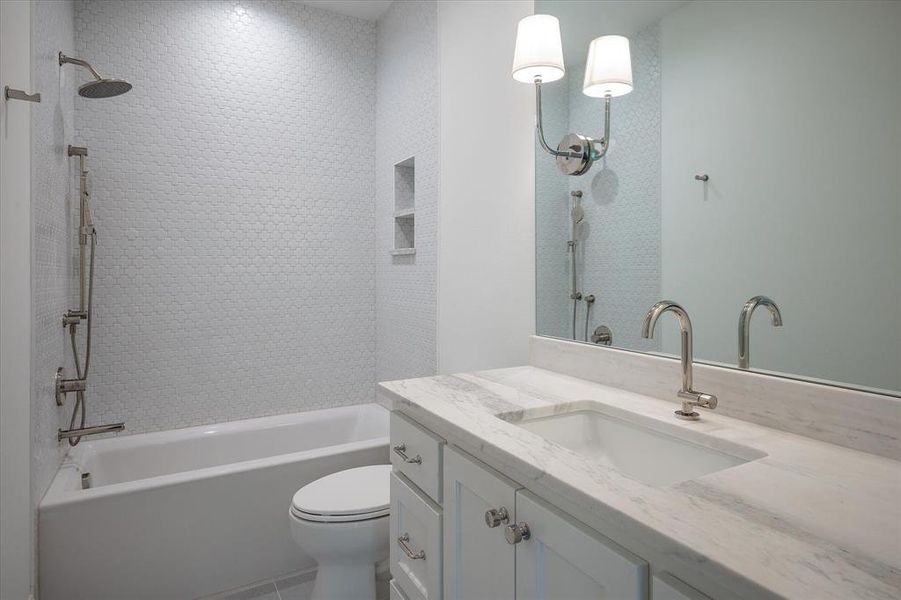 Full bathroom with tiled shower / bath, toilet, and vanity