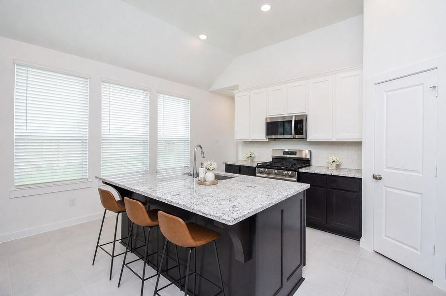 Another wall of windows lights this gorgeous kitchen area. Another wall of windows lights this gorgeous kitchen area.