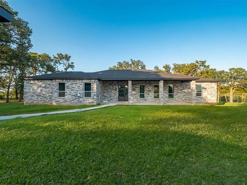 View of front of home featuring a patio area and a front yard