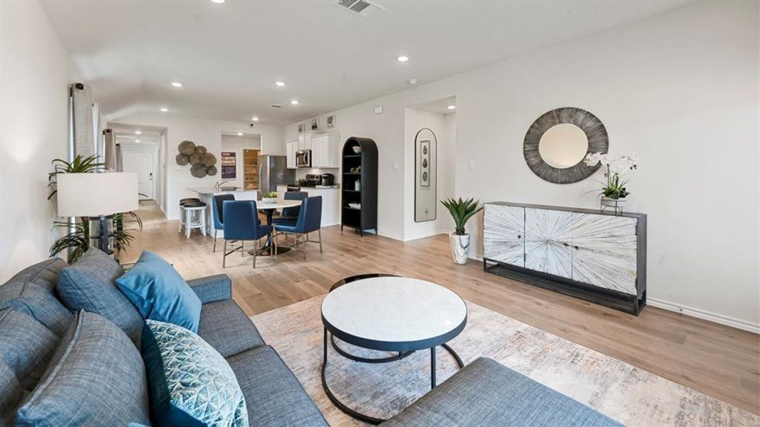 Living room featuring recessed lighting, light wood-type flooring, and arched walkways Living room featuring recessed lighting, light wood-type flooring, and arched walkways