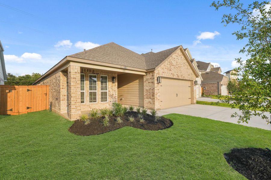 Front exterior of a new home in Sunterra North, Katy, TX, highlighting curb appeal (Image 11). Front exterior of a new home in Sunterra North, Katy, TX, highlighting curb appeal (Image 11).
