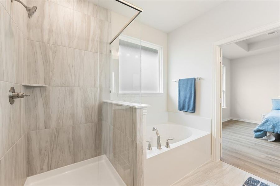 Ensuite bathroom with a garden tub, a tile shower, and wood finished floors