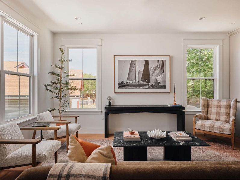 Living area with baseboards and wood finished floors