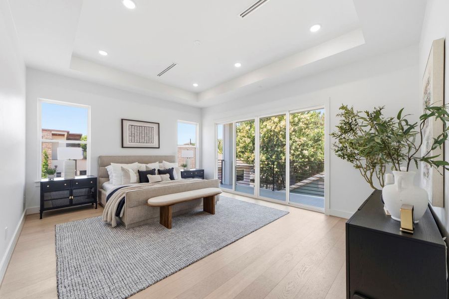 The primary bedroom is a tranquil retreat, featuring large windows and sliding glass doors that open to a balcony. The space is enhanced by beautiful white oak engineered floors. This photo showcases a completed project by Niche Homes. The primary bedroom is a tranquil retreat, featuring large windows and sliding glass doors that open to a balcony. The space is enhanced by beautiful white oak engineered floors. This photo showcases a completed project by Niche Homes.