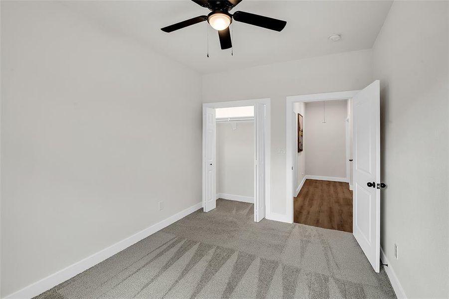 2nd Bedroom with ceiling fan, a closet with wood-like flooring, and carpet flooring