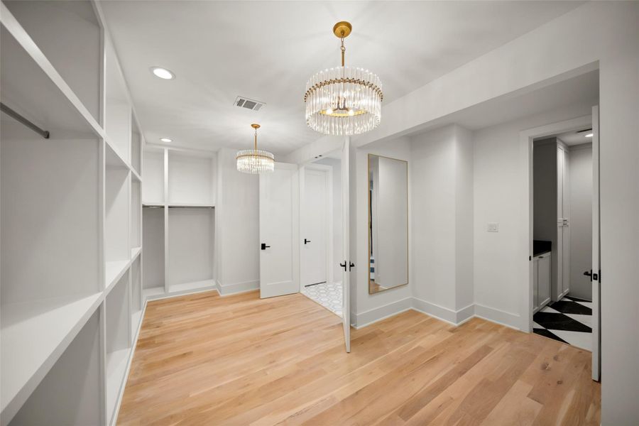A GENEROUS PRIMARY CLOSET WITH A FULL LENGTH MIRROR A GENEROUS PRIMARY CLOSET WITH A FULL LENGTH MIRROR