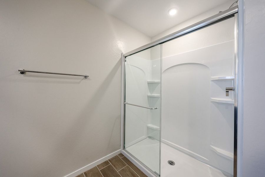 A shower unit in a bathroom. A shower unit in a bathroom.