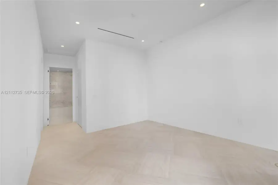 Parquet wood-finish flooring, recessed lighting, and a linear slot diffuser
