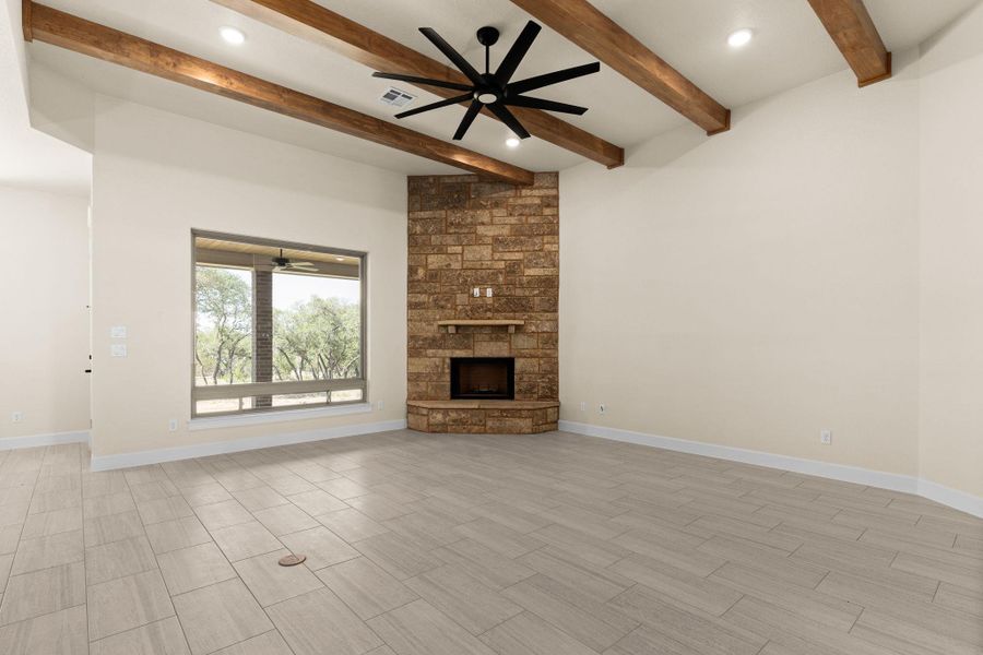 Unfurnished living room featuring a fireplace, a ceiling fan, wood finish floors, recessed lighting, and beam ceiling Unfurnished living room featuring a fireplace, a ceiling fan, wood finish floors, recessed lighting, and beam ceiling