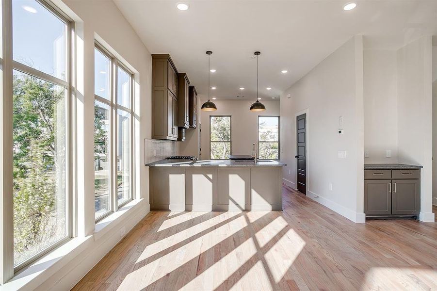 Modern luxury kitchen featuring rich wood cabinetry, quartzite countertops, and dramatic stone surfaces. Modern luxury kitchen featuring rich wood cabinetry, quartzite countertops, and dramatic stone surfaces.