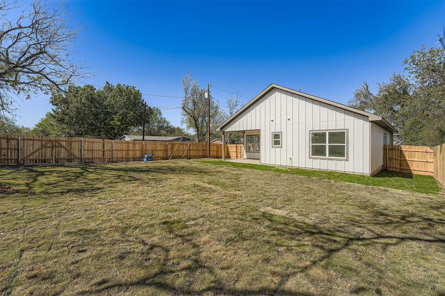 Spacious fenced backyard with plenty of open green space, perfect for outdoor activities and entertaining Spacious fenced backyard with plenty of open green space, perfect for outdoor activities and entertaining