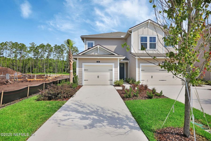 Front exterior of a new home in Woodland Park, Ponte Vedra, FL, highlighting curb appeal (Image 2).