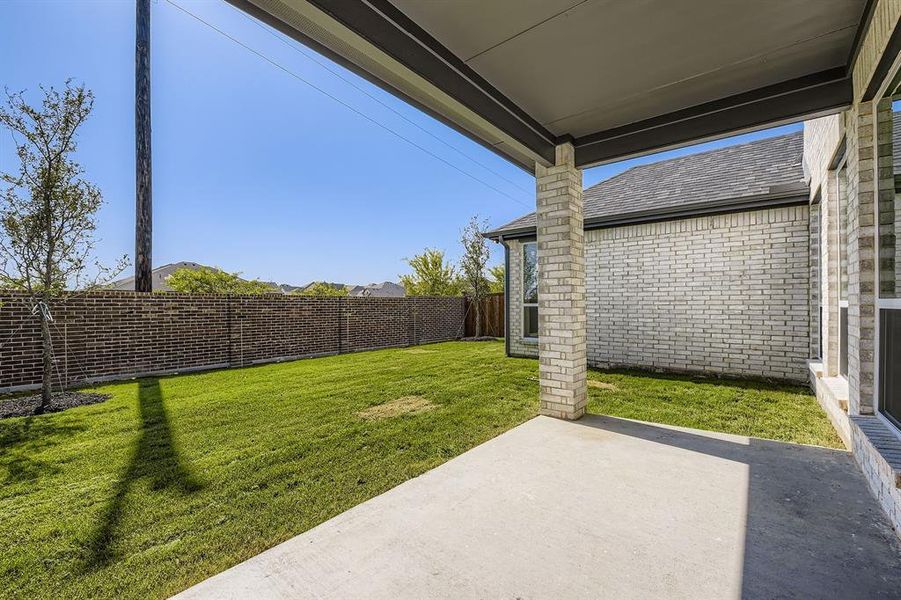 Fenced backyard featuring a patio area Fenced backyard featuring a patio area
