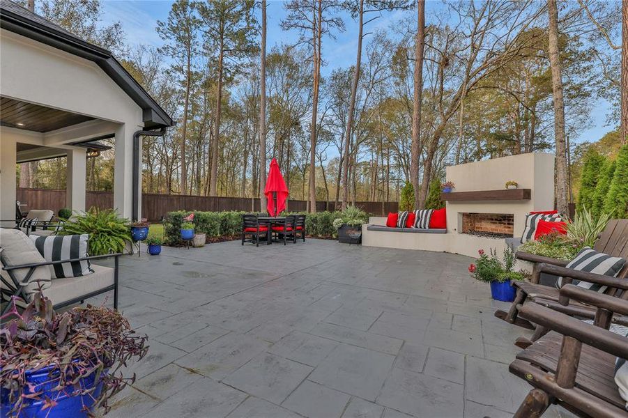 Large covered area. Larger uncovered area with fireplace and built in seating. Beautifully landscaped around the entire back yard.