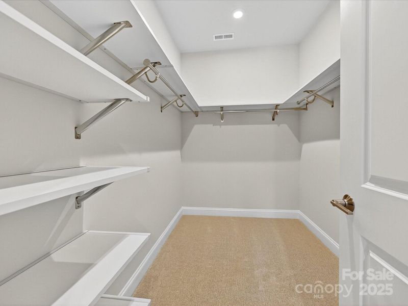 Primary Walk-In Closet and Upgraded Shelving.