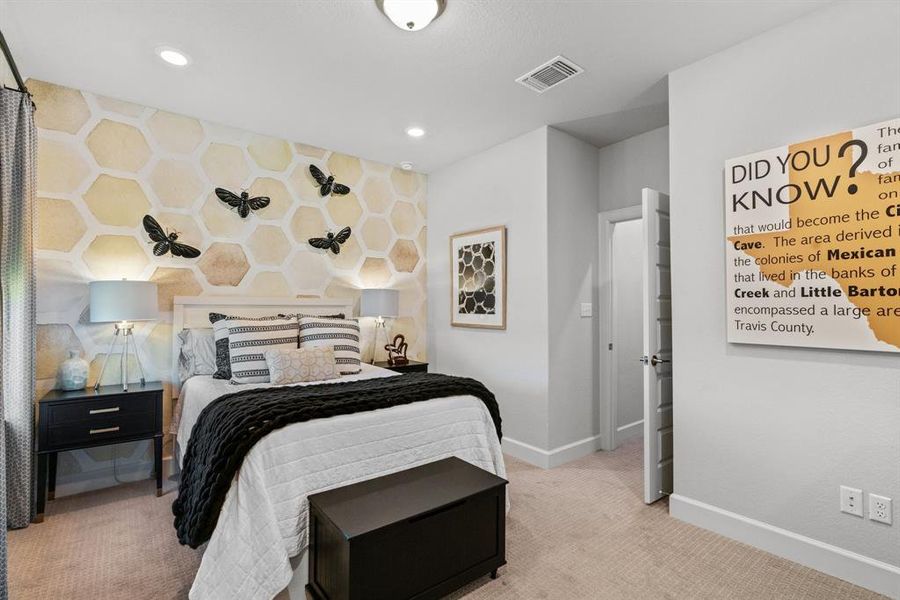 Another nice-sized bedroom with recessed lighting and carpet flooring.