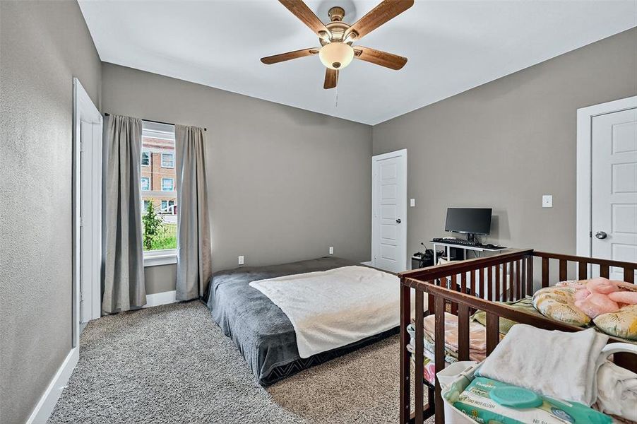 Carpeted bedroom featuring baseboards and a ceiling fan Carpeted bedroom featuring baseboards and a ceiling fan