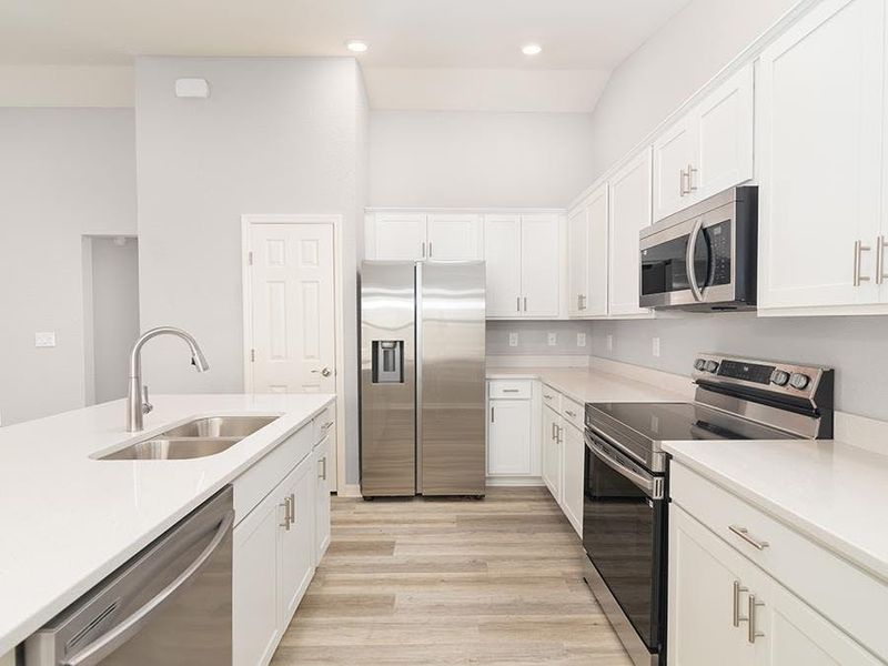 Your new kitchen lives large with an island, ample counter space, and a pantry - Ashlyn by Highland Homes